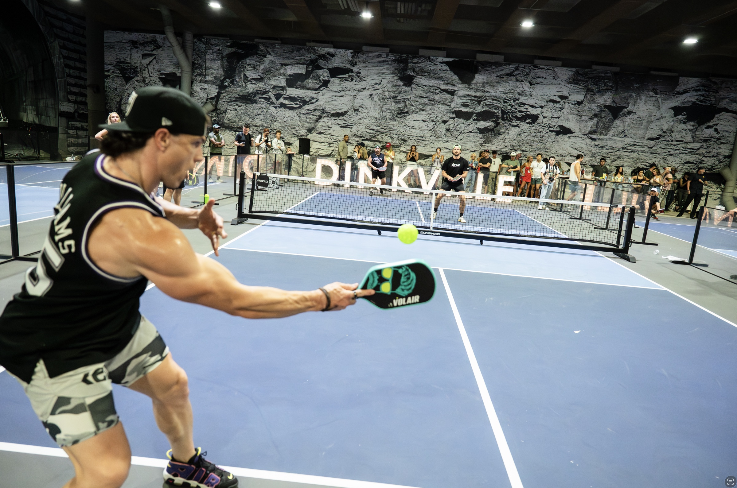 A player returning the ball during a packed Dinkville event