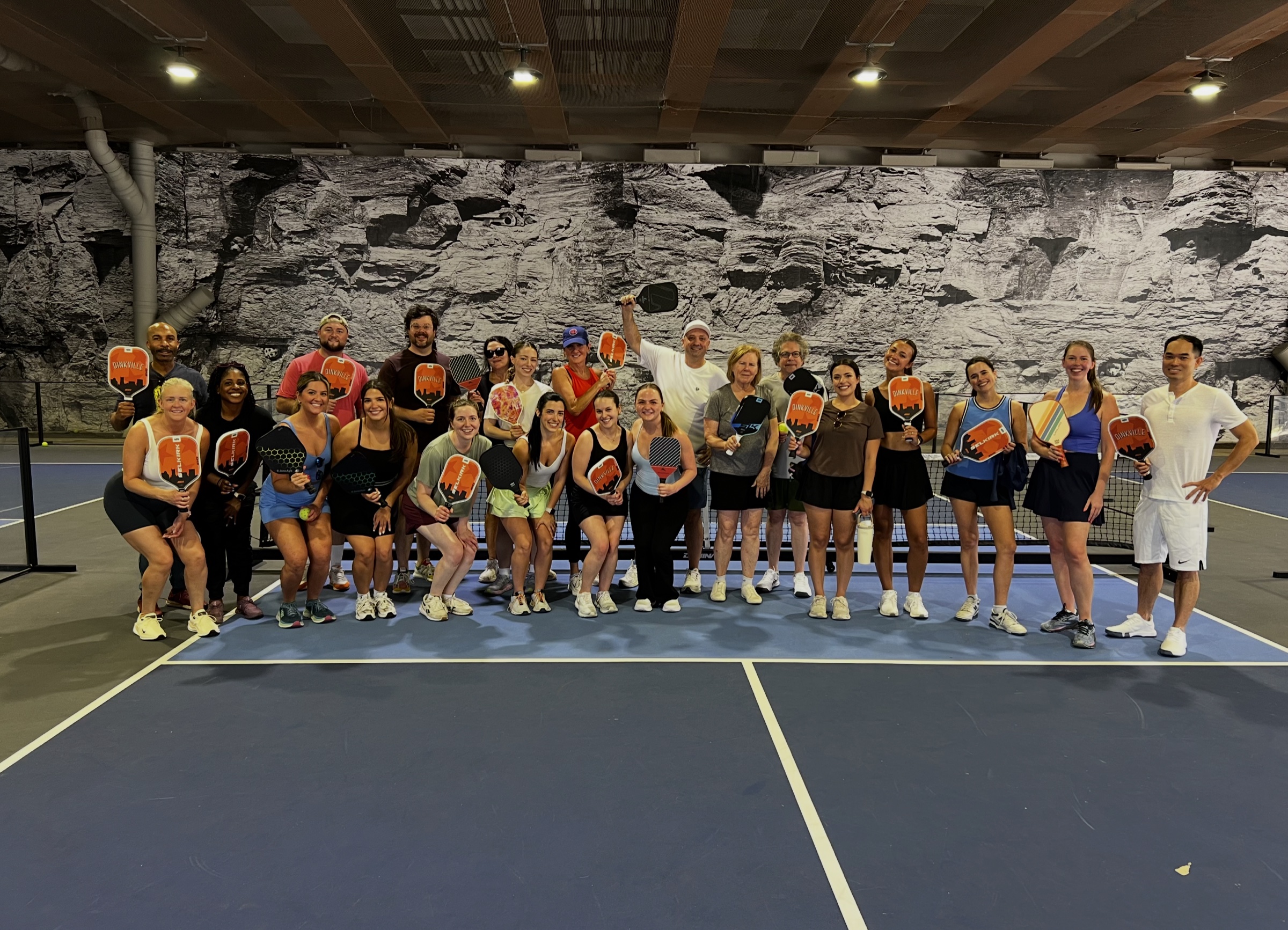 A private group smiling together on a Dinkville court