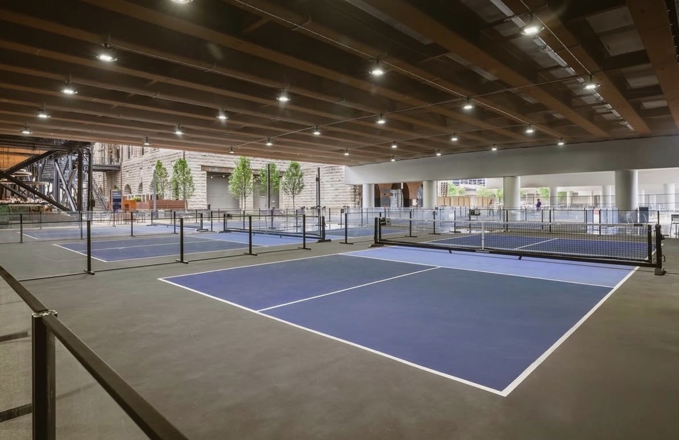 Five pickleball courts beneath the Broadway bridge at Dinkville